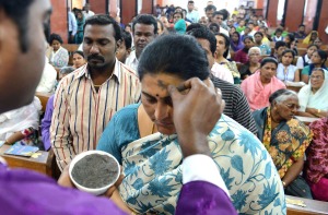 An Indian Catholic priest (L) marks the symbol of the cross with ash on the forehead of a Christian devotee during an Ash Wednesday service at Saint Mary's Basilica in Secunderabad, the twin city of Hyderabad, on February 18, 2015. Catholics began the 40-day observation of Lent on "Ash Wednesday", which culminates on Easter Sunday.       AFP PHOTO / Noah SEELAMNOAH SEELAM/AFP/Getty Images ORG XMIT:
